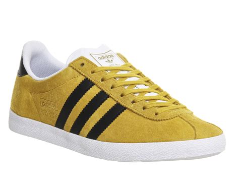 mustard yellow adidas shoes.